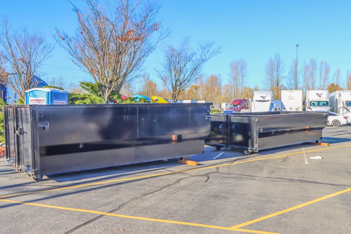 Professional dumpster rental service with roll-off container on residential driveway in Crozet